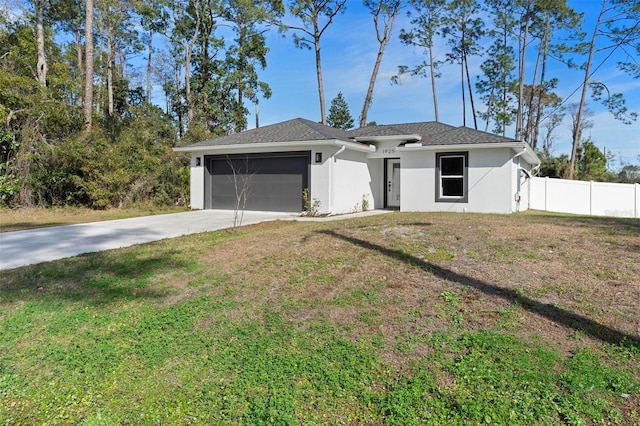 single story home with a garage and a front lawn