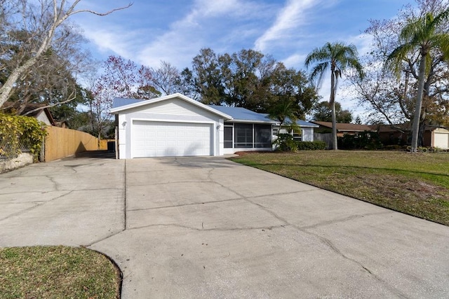 ranch-style house featuring a garage and a front yard