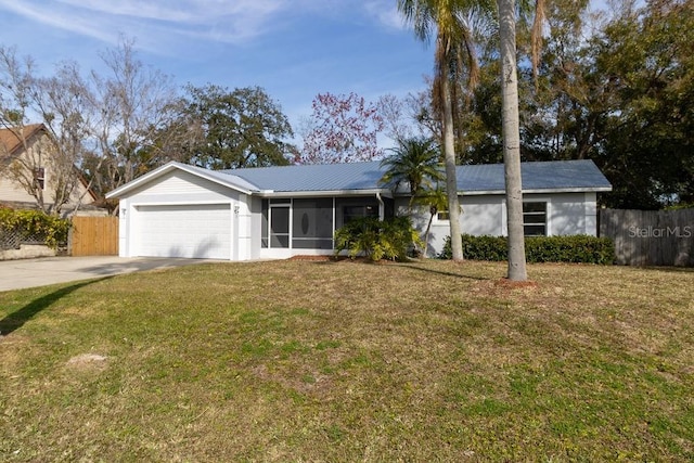 ranch-style home with a garage, a sunroom, and a front lawn