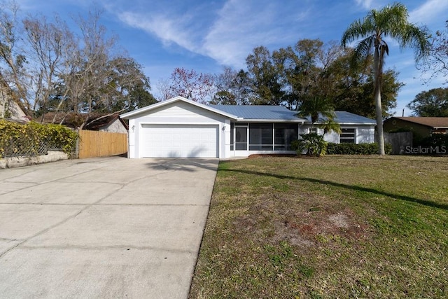 single story home with a sunroom and a front yard