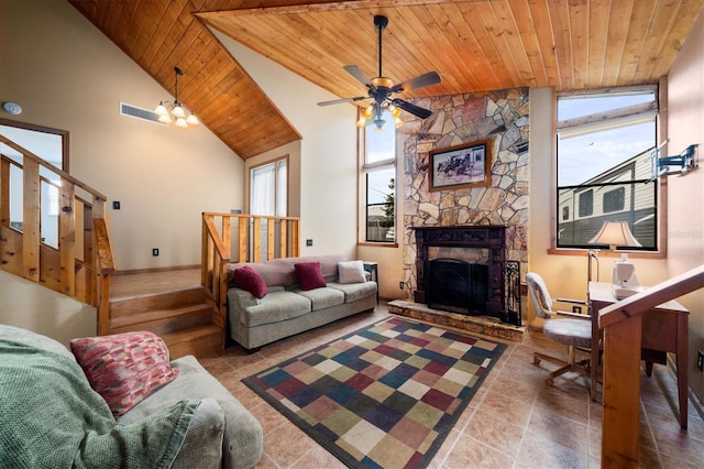 living room featuring ceiling fan with notable chandelier, a stone fireplace, high vaulted ceiling, and wooden ceiling