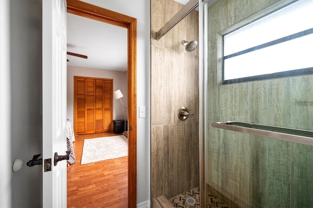 bathroom featuring hardwood / wood-style floors and a shower with shower door