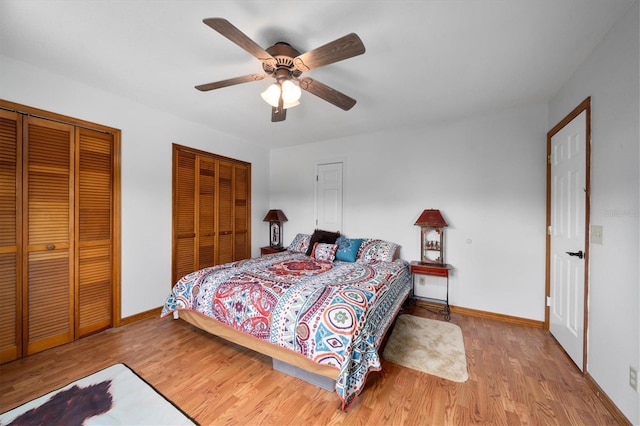 bedroom with multiple closets, ceiling fan, and light wood-type flooring