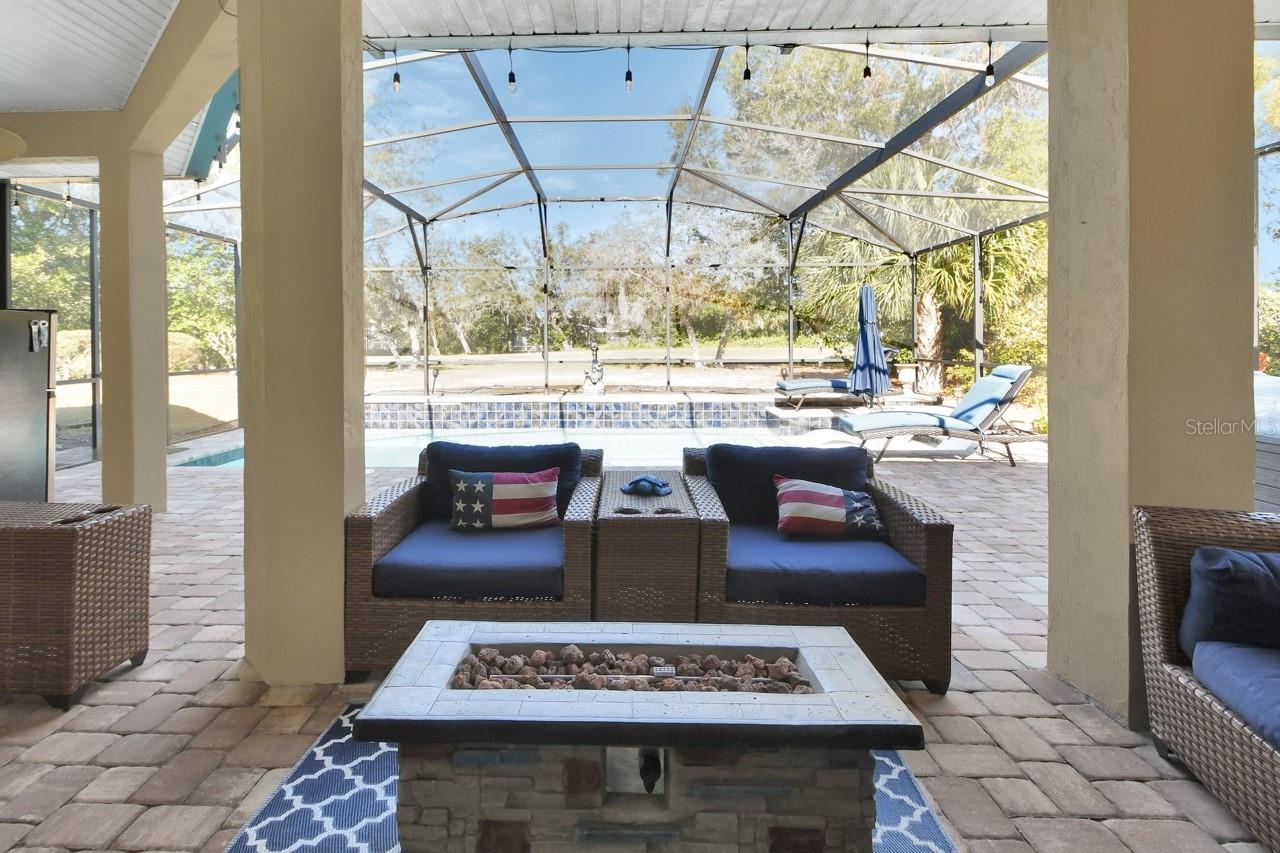 428 Hightower Dr, Debary, FL 32713 - view of patio / terrace with an outdoor living space with a fire pit and a lanai