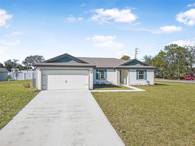 single story home with a garage and a front lawn