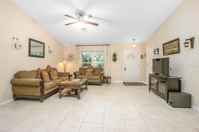 tiled living room featuring ceiling fan and vaulted ceiling