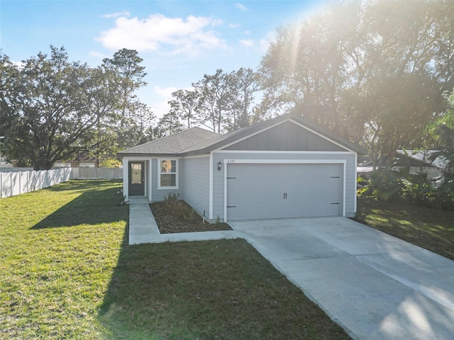 ranch-style house featuring a garage and a front yard