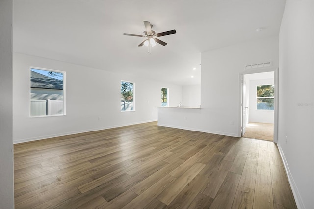 unfurnished living room featuring hardwood / wood-style floors and ceiling fan