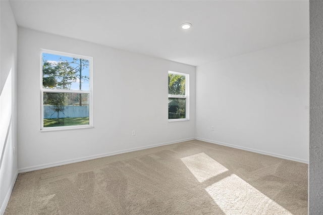 unfurnished room with light carpet