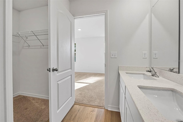 bathroom featuring vanity and wood-type flooring