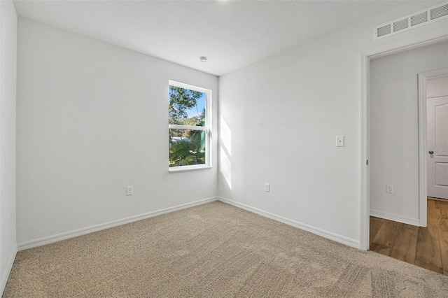 unfurnished room featuring carpet flooring