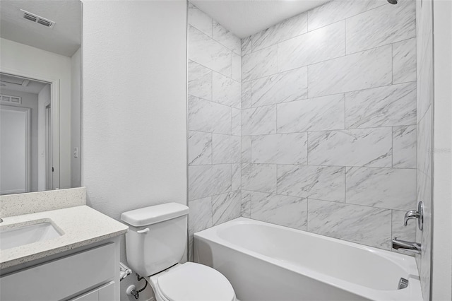 full bathroom with vanity, toilet, and tiled shower / bath combo