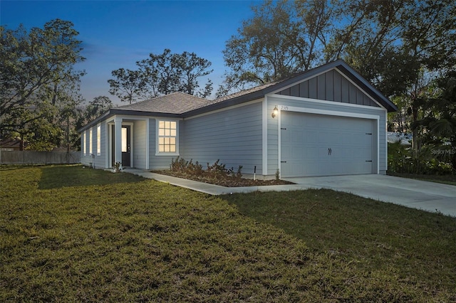 property exterior at dusk with a garage and a yard