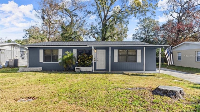 single story home featuring a carport, central AC unit, and a front lawn