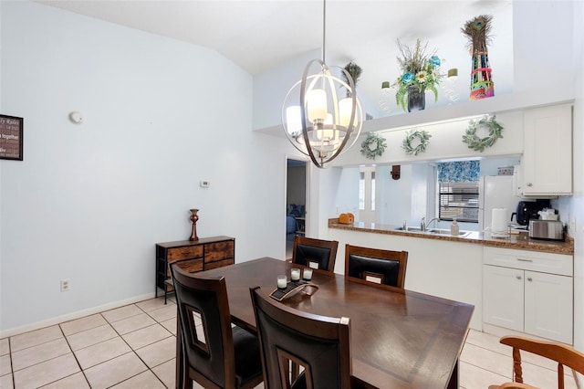 tiled dining area with lofted ceiling, a chandelier, and sink