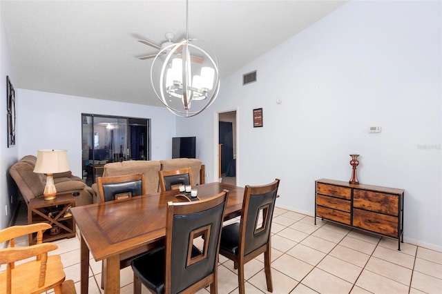 dining space featuring an inviting chandelier, lofted ceiling, and light tile patterned floors