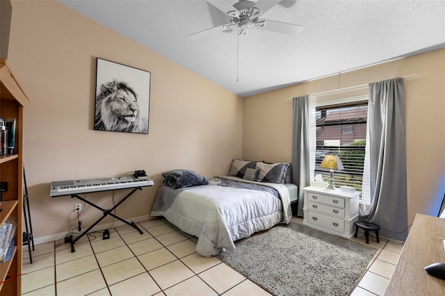 tiled bedroom featuring lofted ceiling, a textured ceiling, and ceiling fan