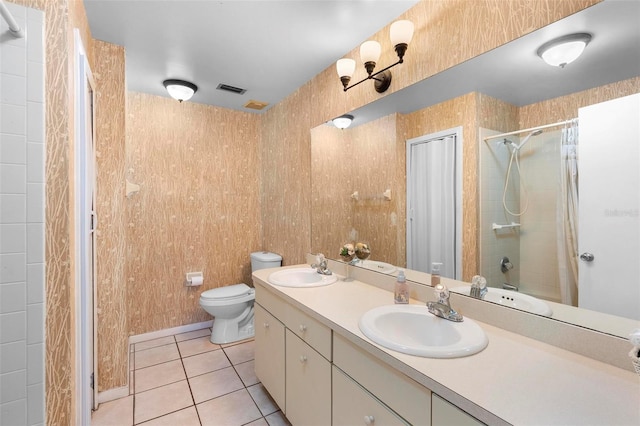 full bathroom featuring vanity, toilet, tiled shower / bath combo, and tile patterned flooring