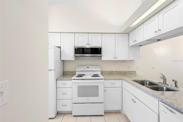 245 Terrace Hill Blvd Unit 1E, Debary, FL 32713 - kitchen with white appliances, white cabinetry, light tile patterned flooring, and light stone counters