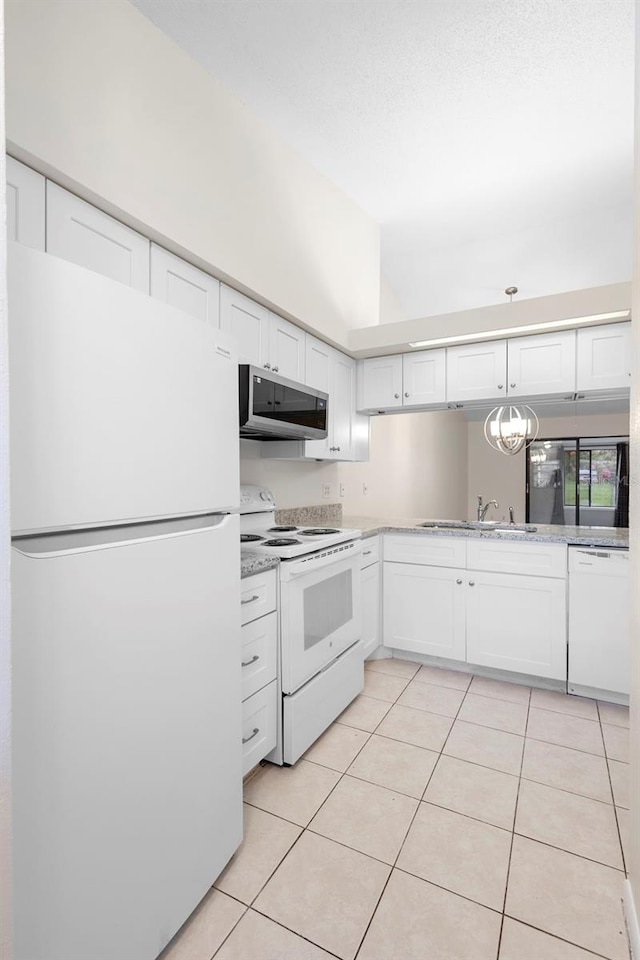 245 Terrace Hill Blvd Unit 1E, Debary, FL 32713 - kitchen with white appliances, white cabinetry, and light tile patterned floors