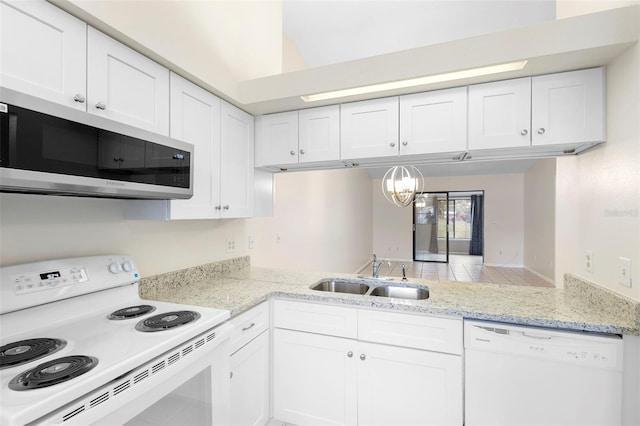 245 Terrace Hill Blvd Unit 1E, Debary, FL 32713 - kitchen featuring white appliances, a chandelier, white cabinets, and light stone counters
