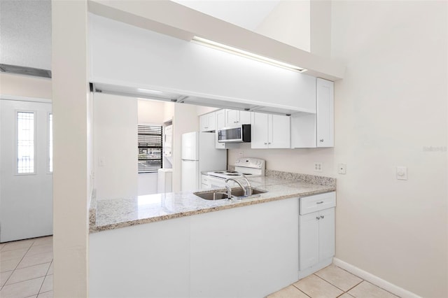 245 Terrace Hill Blvd Unit 1E, Debary, FL 32713 - kitchen featuring white appliances, light tile patterned floors, white cabinets, and light stone countertops