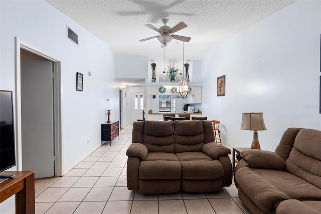 245 Terrace Hill Blvd Unit 1E, Debary, FL 32713 - living area featuring ceiling fan, light tile patterned floors, a textured ceiling, and a chandelier