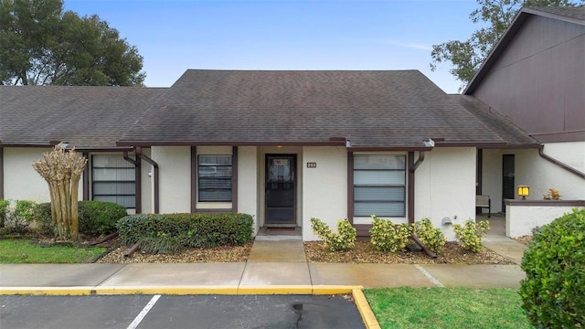 245 Terrace Hill Blvd Unit 1E, Debary, FL 32713 - view of front of home featuring stucco siding, uncovered parking, and a shingled roof