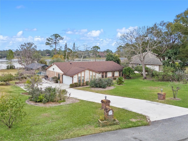 ranch-style home featuring a garage and a front lawn