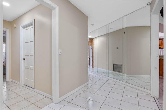 hall featuring light tile patterned flooring