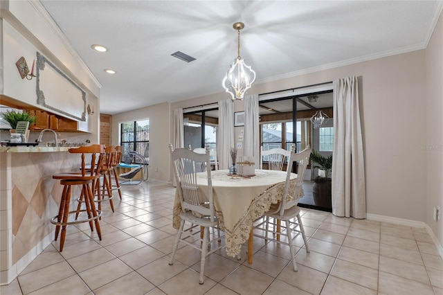 tiled dining space featuring crown molding and an inviting chandelier