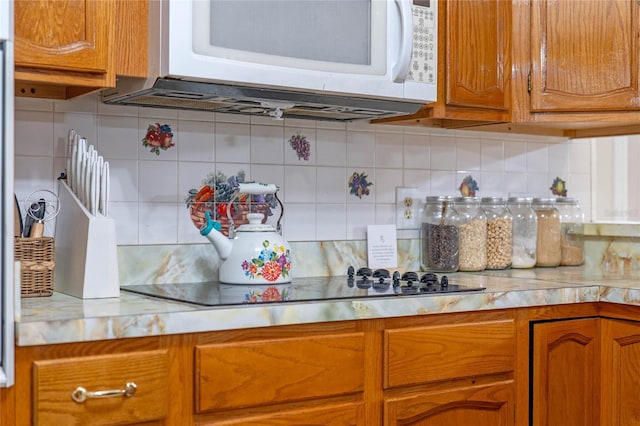 kitchen featuring tasteful backsplash and black electric stovetop