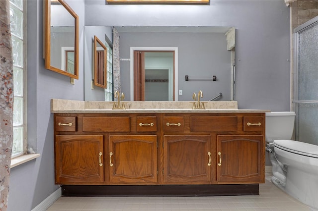 bathroom with walk in shower, a healthy amount of sunlight, toilet, and vanity