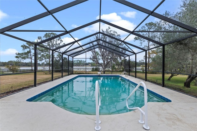 view of swimming pool with a lanai, a patio area, and a lawn