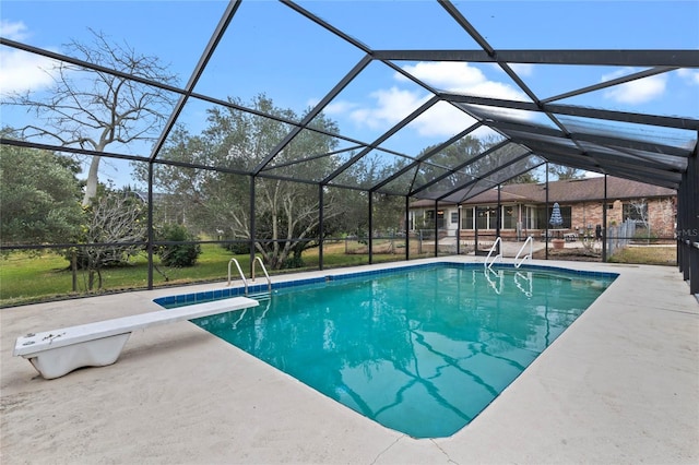 view of pool featuring a patio, a diving board, and glass enclosure