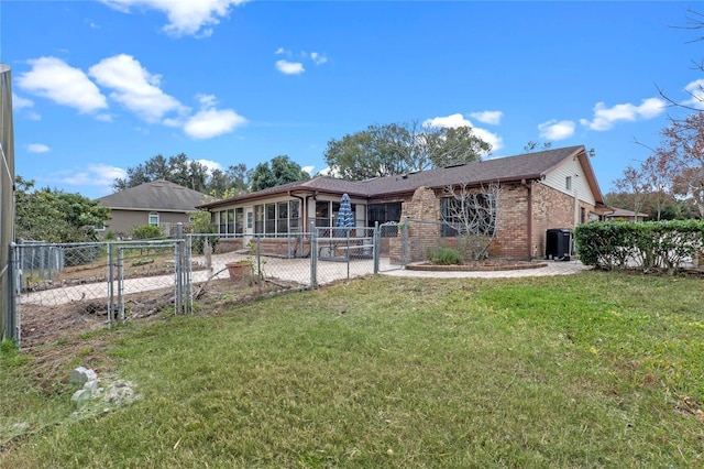 rear view of property featuring a lawn