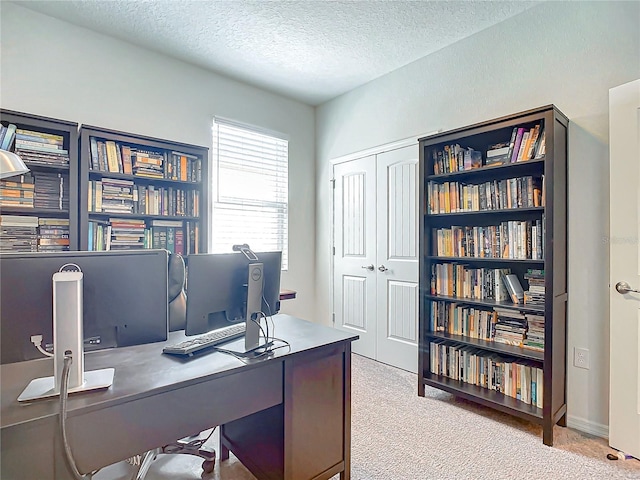 office area featuring carpet flooring and a textured ceiling