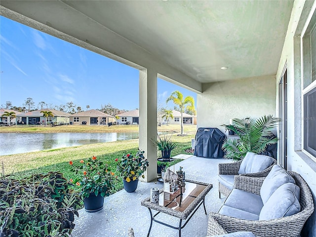 view of patio / terrace with a water view and a grill