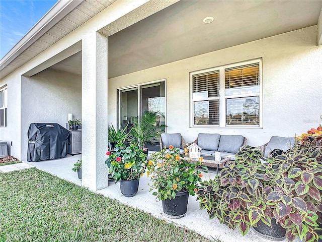 exterior space featuring an outdoor hangout area and a patio