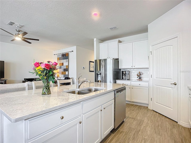 kitchen with white cabinetry, sink, an island with sink, and appliances with stainless steel finishes