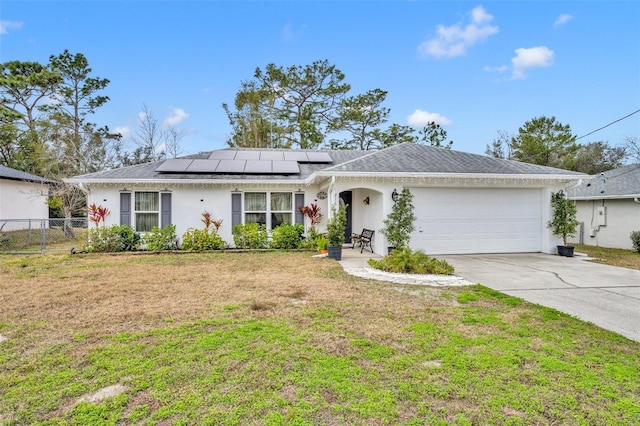 single story home with a garage, a front lawn, and solar panels