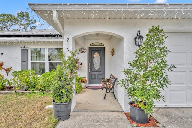 property entrance with a garage and solar panels