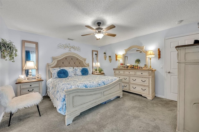 bedroom with light carpet, a textured ceiling, and ceiling fan