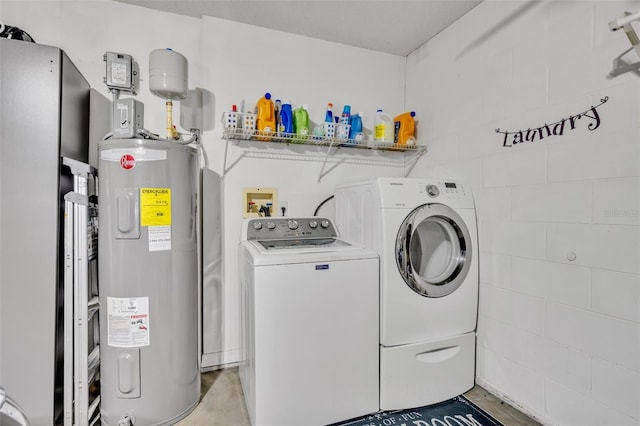 laundry area with electric water heater and washing machine and dryer