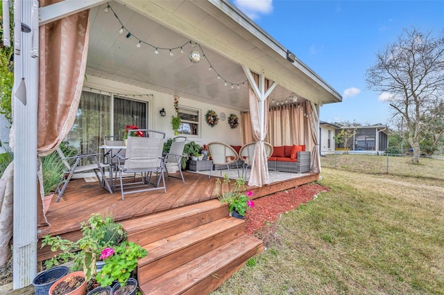 wooden terrace with a lawn