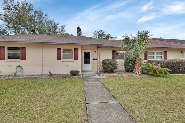 ranch-style home with a front lawn