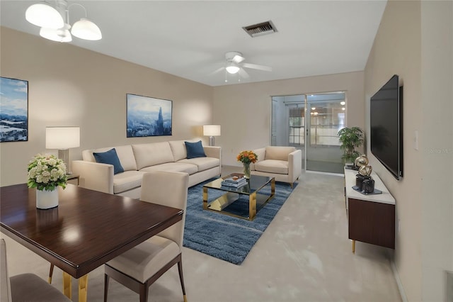 living room with ceiling fan with notable chandelier