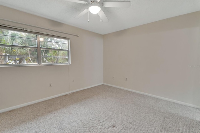 spare room featuring carpet flooring and ceiling fan