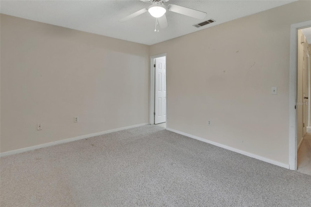 spare room with light carpet and ceiling fan