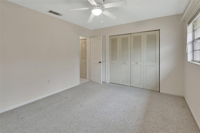 unfurnished bedroom featuring ceiling fan and light colored carpet